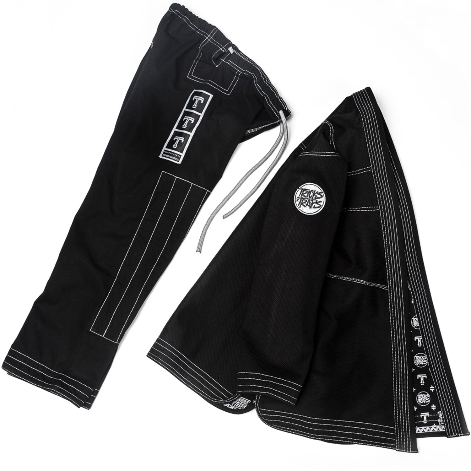 Tricks and Traps Jiu Jitsu Gi.  Black and Silver color way with a 550gsm pearl weave jacket and 10oz ripstop pants.