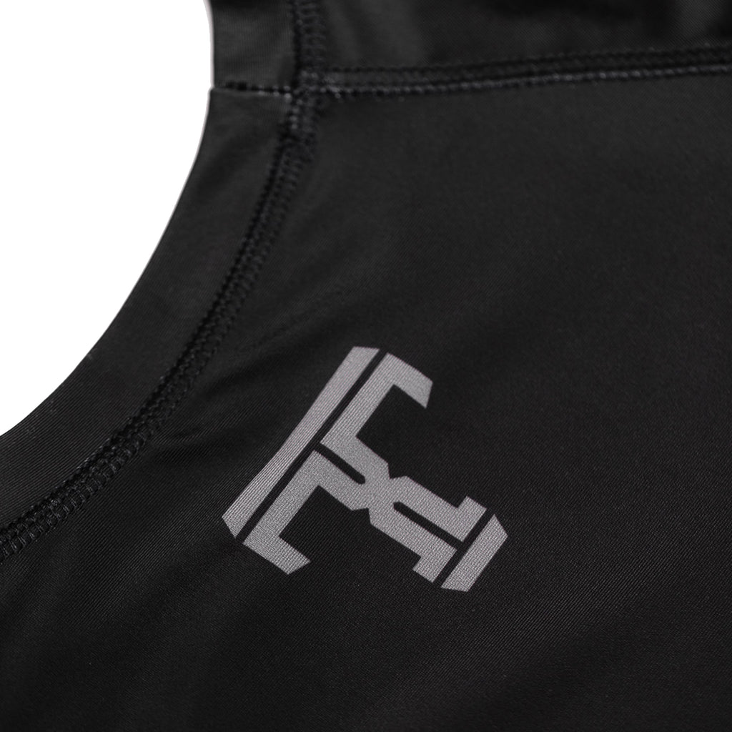 Tricks and Traps logo on a black and silver rash guard