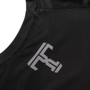 Tricks and Traps logo on a black and silver rash guard